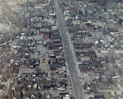 An Aerial View Of A City With Lots Of Houses And Streets In The Foreground