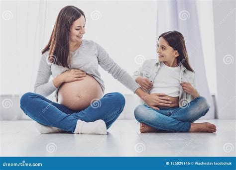 Femme Enceinte Optimiste Touchant Son Estomac De Filles Photo Stock