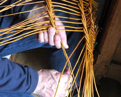 A Person Is Working On Some Kind Of Art Project With Sticks And Yarn In