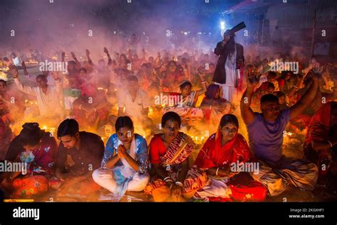 Bangladeshi Hindu Devotees Sit With Candles And Pray To God At The Shri