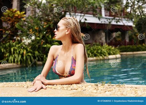 Woman With Blond Hair In Bikini Relaxing In Swimming Pool Stock Image