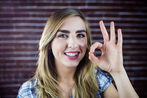 Premium Photo Pretty Blonde Woman Making Signs With Her Fingers