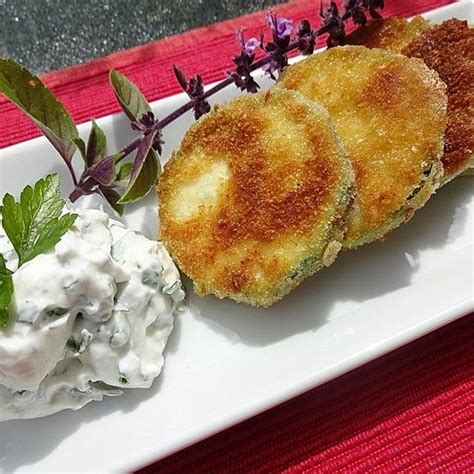 Some Food Is On A White Plate And Garnished With Herbs