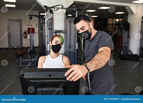 Personal Trainer And Sporty Woman Exercising Wearing Face Masks During