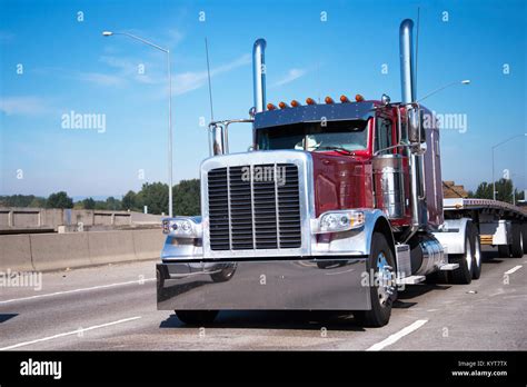 Classic Big Rig Semi Truck In Dark Red With High Chrome Pipes And