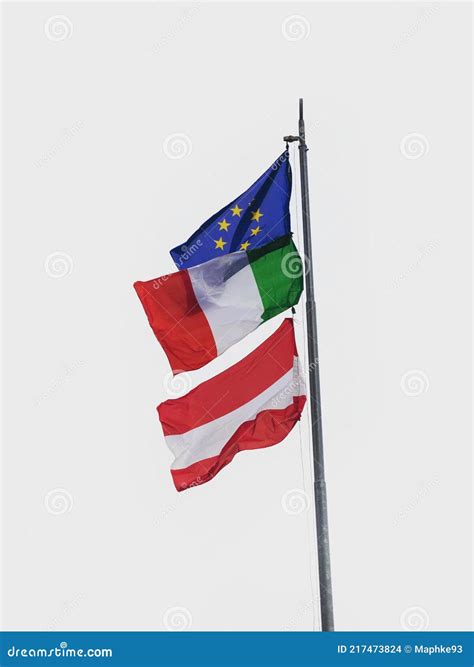 European Italian And Austrian Flag Waving In The Wind At Tre Cime Di