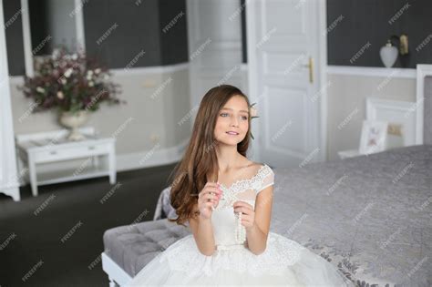 Premium Photo | Smiling cheerful little girl in a beautiful white ball ... 