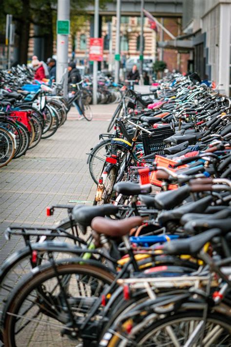 Bicycles Parked In The Streets Of Amsterdam The Netherlands Green And