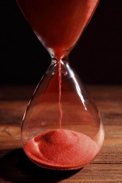 Premium Photo Time Passing Concept Crystal Hourglass With Red Sand On