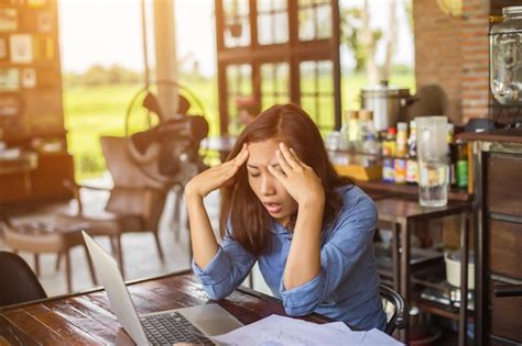 Premium Photo Stressed Businesswoman Using Laptop While Sitting In Cafe