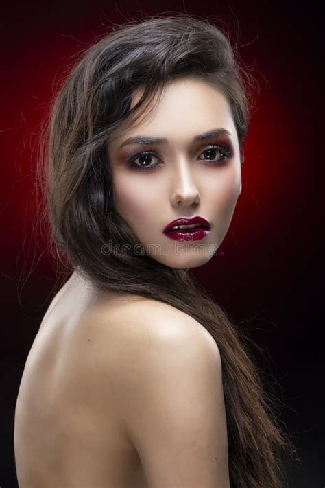 Portrait Of A Beautiful Glamorous Brunette Girl With Naked Shoulders Shimmering Makeup Red