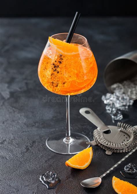 Glass Of Aperol Spritz Summer Cocktail With Orange Slices And Strainer With Jigger And Cocktail