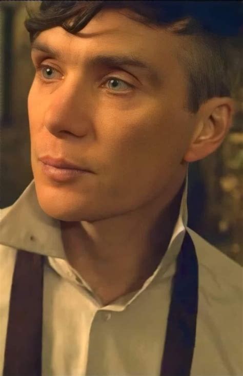 A Close Up Of A Person Wearing Suspenders And A White Shirt With Blue Eyes