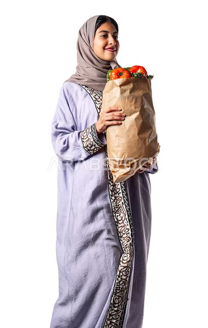 Portrait Of A Veiled Saudi Arabian Gulf Woman Carrying A Bag Of