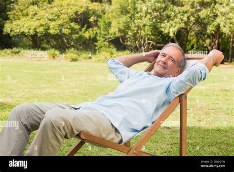 Happy Mature Man Sitting On Sun Lounger Stock Photo Alamy