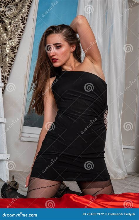 Slim Brunette Woman Posing In Bed Looking At Camera Lady Wearing Sensual Lingerie Stock Photo