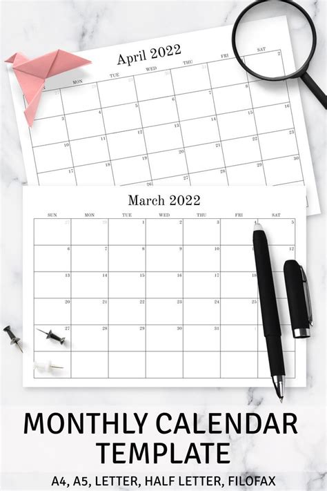 the month calendar is on top of a marble table next to a pair of scissors