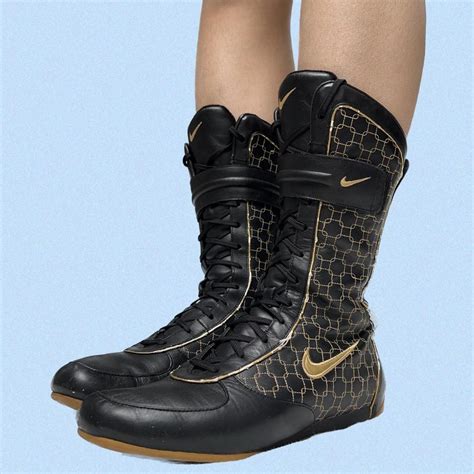 Nike Women's Black and Gold Boots | Depop