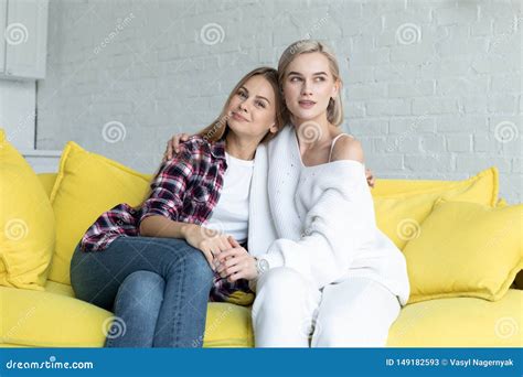 Portrait Of Beautiful Lesbian Couple In Casual Clothes That Hugging