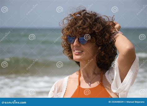 Portrait Of Attractive Mature Woman With Curly Hair Sunglasses And