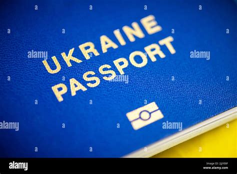 Ukrainian Biometric Passports On National Yellow Blue Flag Close Up