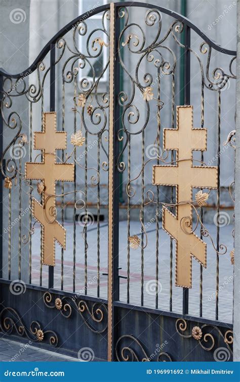 The Entrance To The Christian Church Is Decorated With Metal Crosses