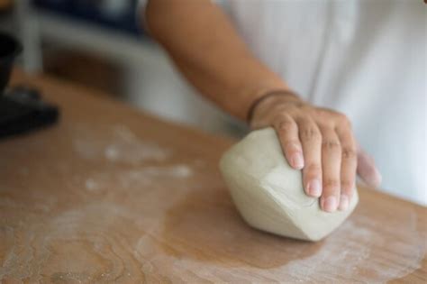 Premium Photo Woman Kneading Clay To Make Pottery