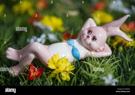 A Figurine Of A Bunny Wearing A Bikini Lies On A Patch Of Artificial