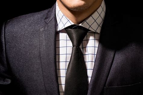 Premium Photo Midsection Of Businessman Standing Against Black Background