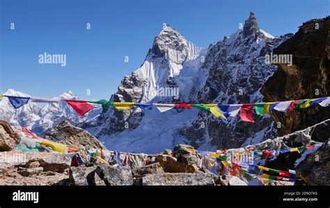 Colorful Buddhist prayer flags peacefully waving in the cold wind on ...