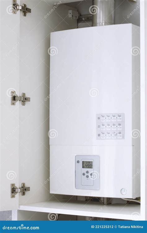 White Electric Water Heater With Electronic Panel Mounted In A Kitchen