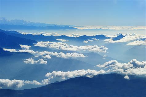 Scenic View of Clouds over Mountains Against Blue Sky · Free Stock Photo