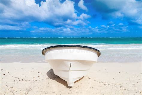 White Pleasure Motor Boat Lays On Sandy Beach Front View Stock Image