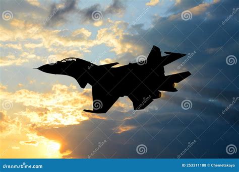 Silhouette of Jet Fighter in Cloudy Sky at Sunrise Stock Photo - Image ...