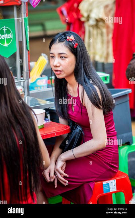 A Beautiful Thai Girl Chats With Her Friend Over Lunch At A Noodle Food Stall On Yaowarat Rd