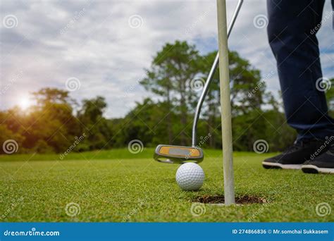 Blurred Golfer Playing Golf In The Evening Golf Course On Sun Set