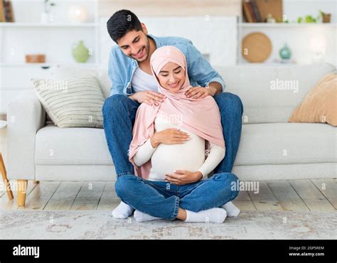 Caring Young Arab Man Massaging His Wifes Shoulders Resting Together