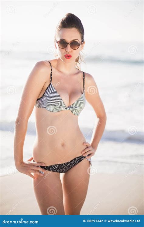 Portrait Of Glamorous Woman In Bikini Standing On The Beach Stock Photo