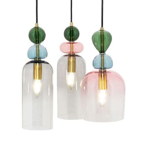 Three Different Colored Glass Lamps Hanging From The Ceiling