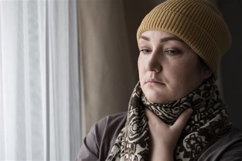 Premium Photo Sick Brunette Woman In Cap And Scarf Holds Throat