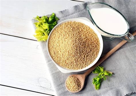 Top View Of Unhulled Foxtail Millet Seeds In Wood Spoon