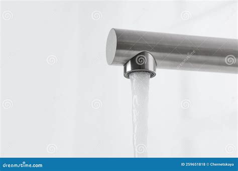 Stream Of Water Flowing From Tap On White Background Closeup Space