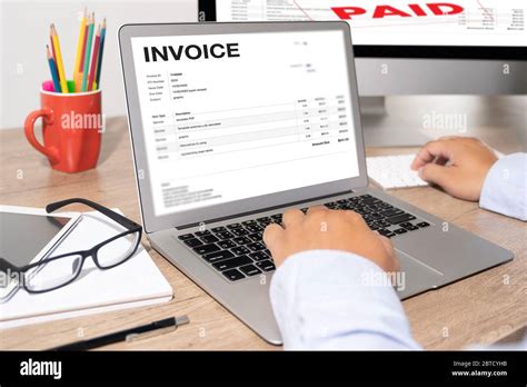 Businessman Work Using The Computer Calculating Invoice In Office