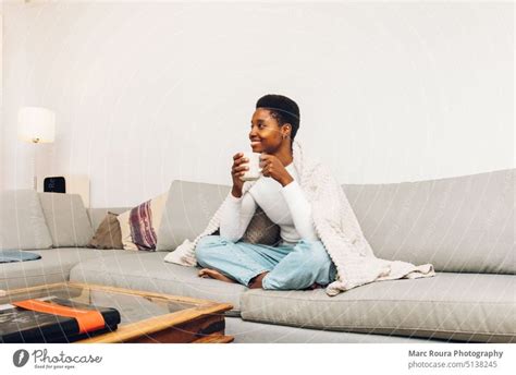 Person Sitting On A Sofa And Drinking Coffee A Royalty Free Stock