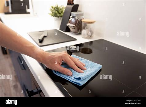 Man cleaning induction stove. Modern kitchen with induction hob Stock Photo - Alamy