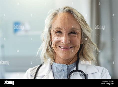 Portrait Of Happy Senior Caucasian Female Doctor Wearing Lab Coat And