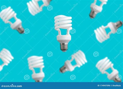 Levitating Energy Saving Light Bulbs On Blue Background Energy Saving