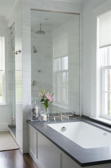 White Bathtub Wainscoting With Black Quartz Tub Deck Transitional