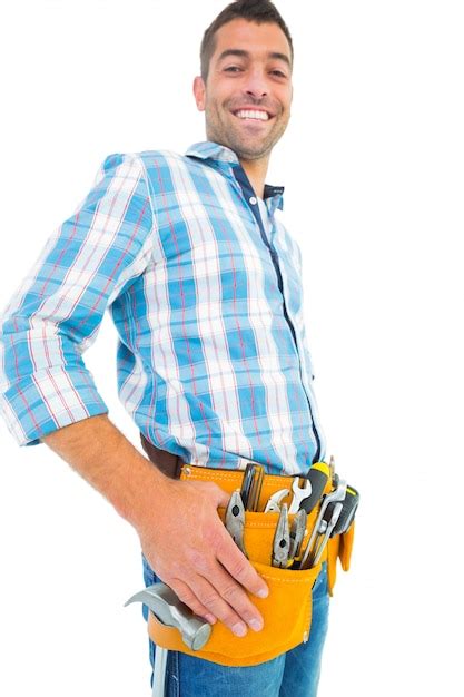 Premium Photo Portrait Of Smiling Handyman Wearing Tool Belt