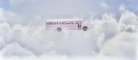 A Pink Bus Is Flying Through The Clouds